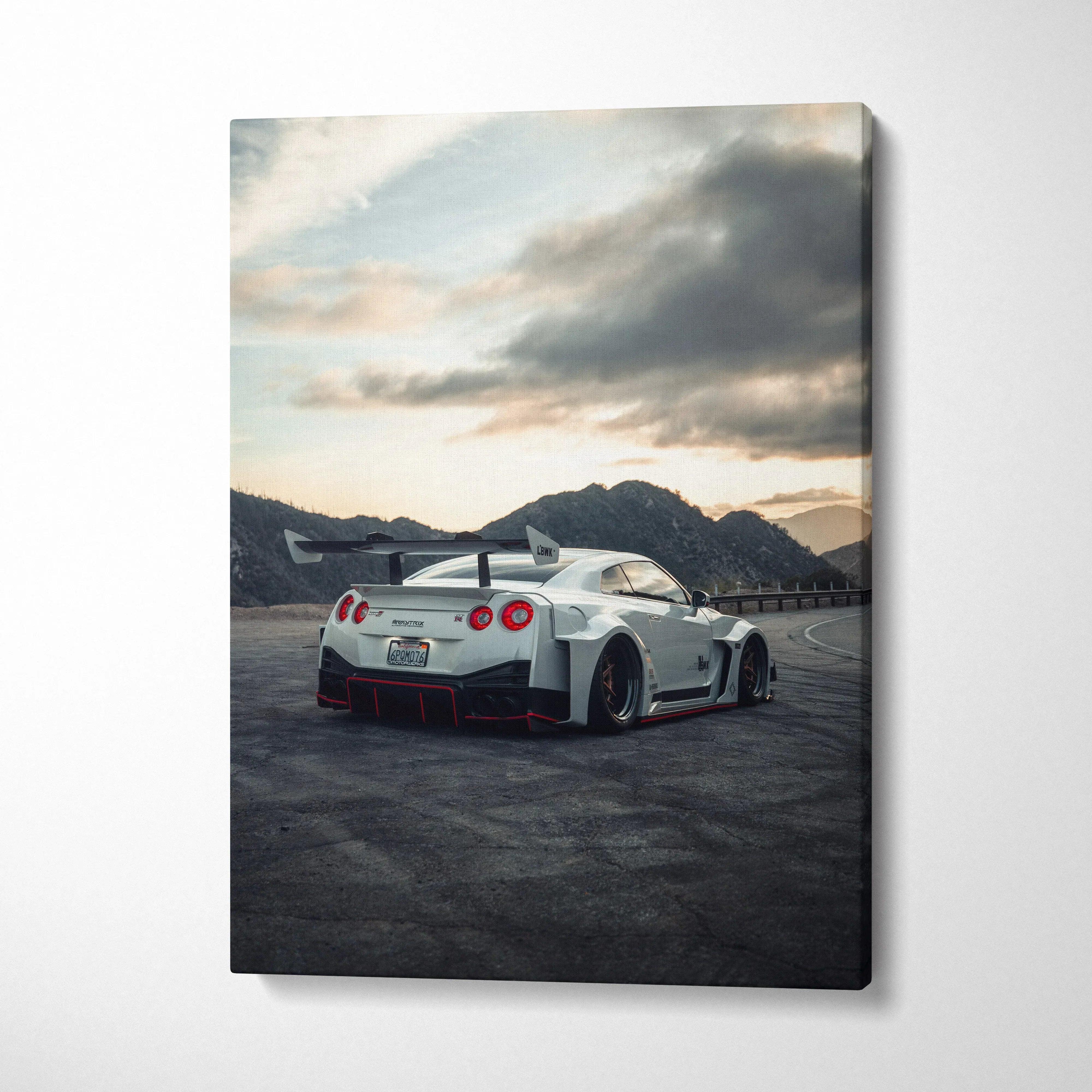 Vertical canvas wall art featuring a white Nissan R35 GTR sports car at sunset with mountainous background.