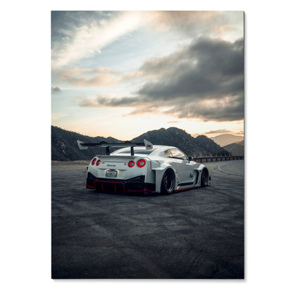 Nissan GTR R35 sports car on open road at sunset poster wall art with dramatic sky.