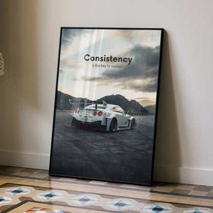 Motivational poster wall art featuring white Nissan R35 GT-R with "Consistency is the key to success" text against cloudy.