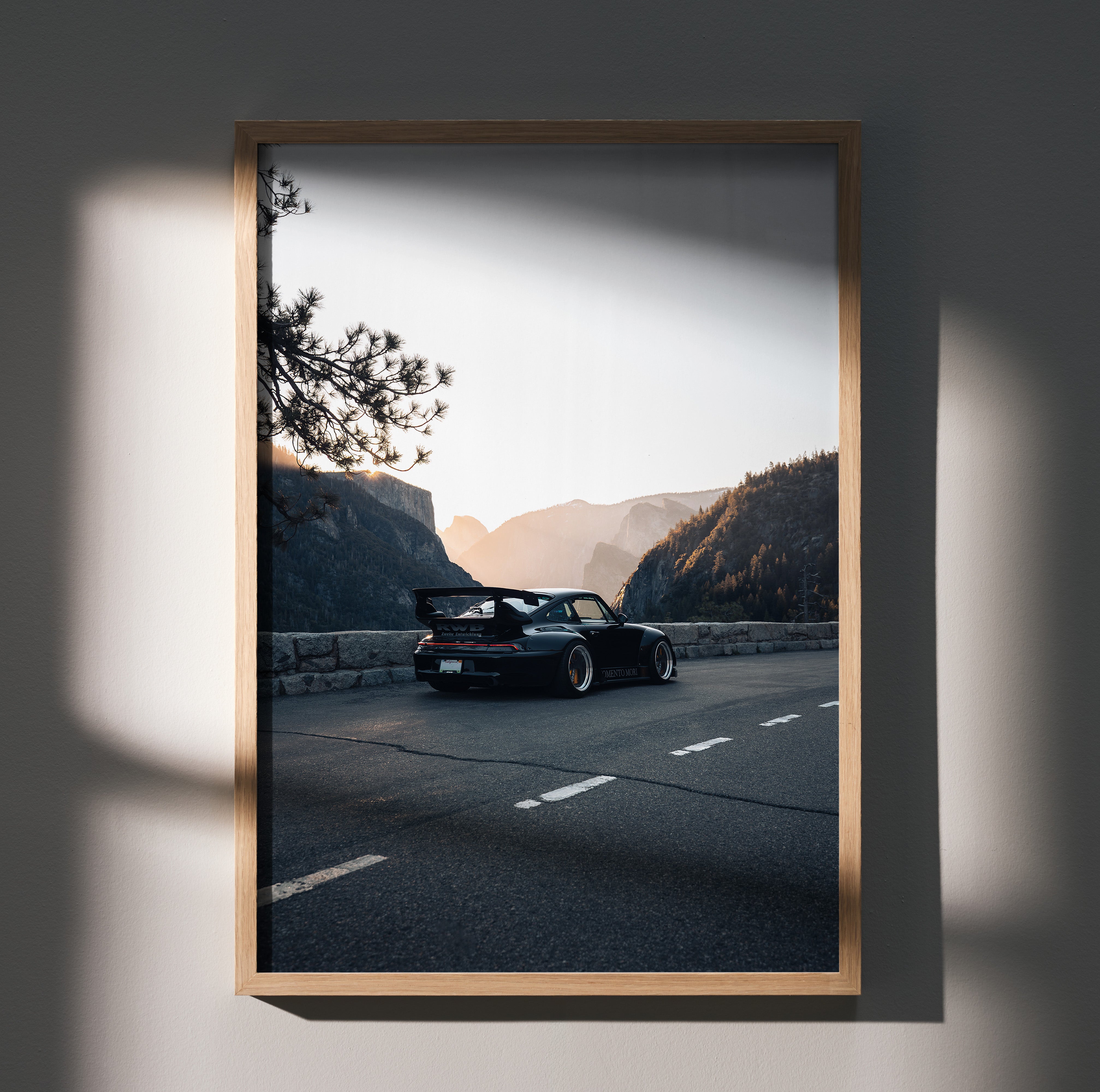 RWB Porsche 911 poster wall art featuring sleek car on mountain road at sunset in wooden frame.