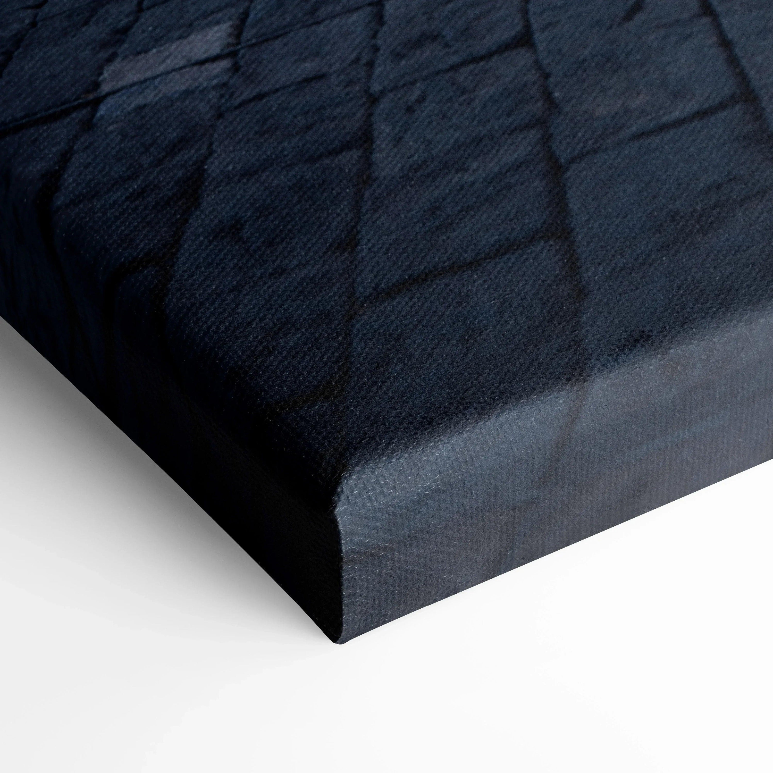 Close-up of black textured canvas art corner with subtle sheen and grid pattern for wall art display.
