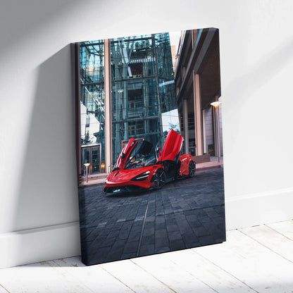 Vertical canvas wall art of red McLaren 765LT with upward doors in urban setting.