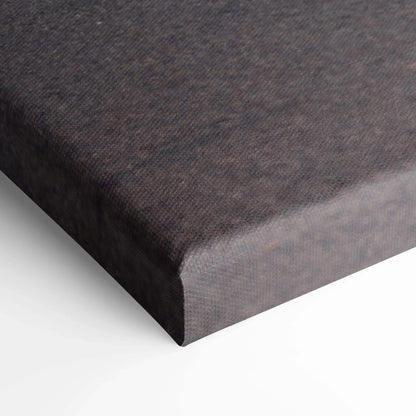 Close-up of black wrapped edge on vertical canvas wall art with fine texture.