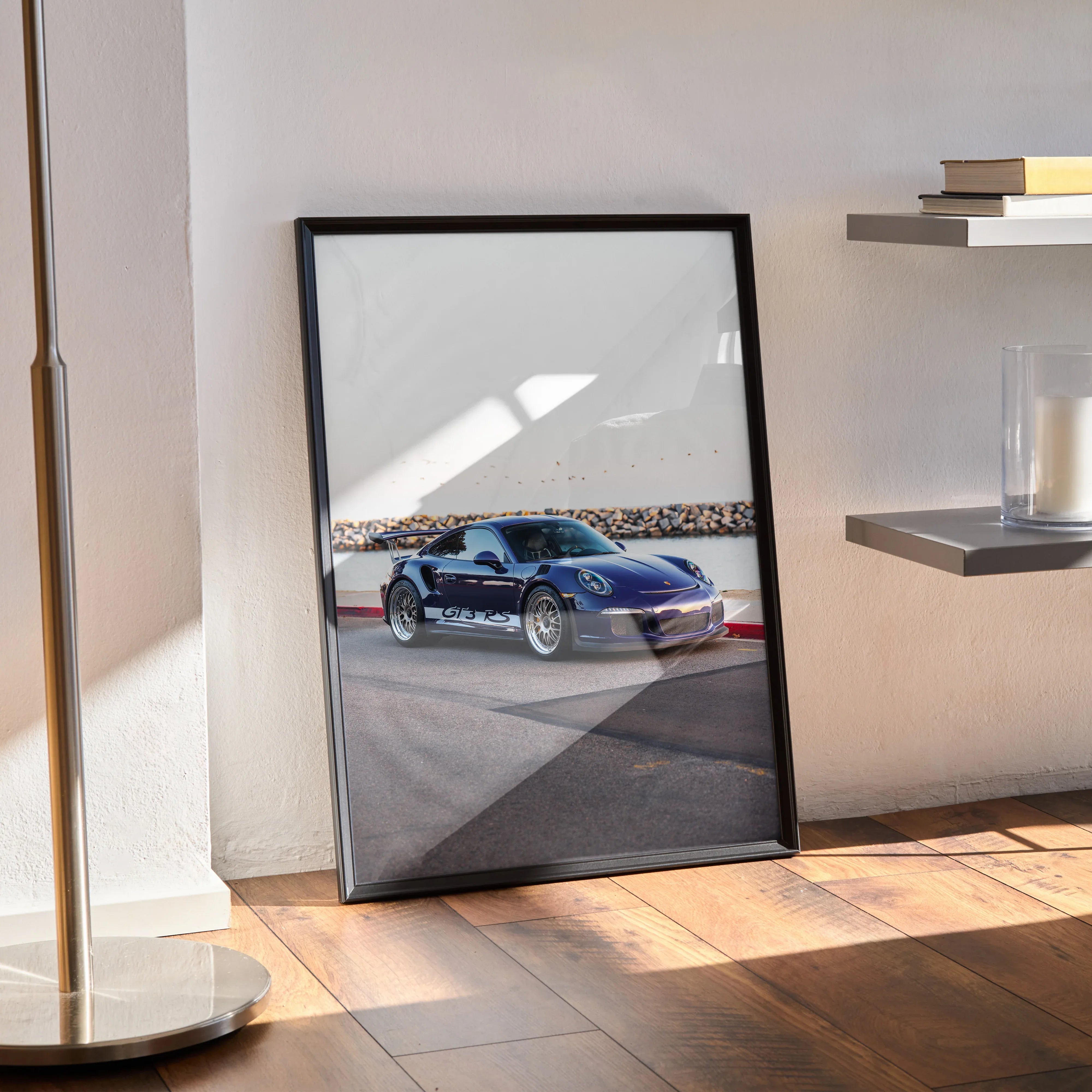 Porsche 911 GT3 RS sports car poster with black frame leaning against wall, modern wall art.
