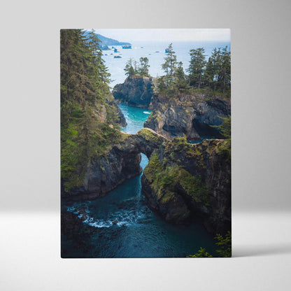 Rugged coastal cliffs with rock arch over emerald water canvas print