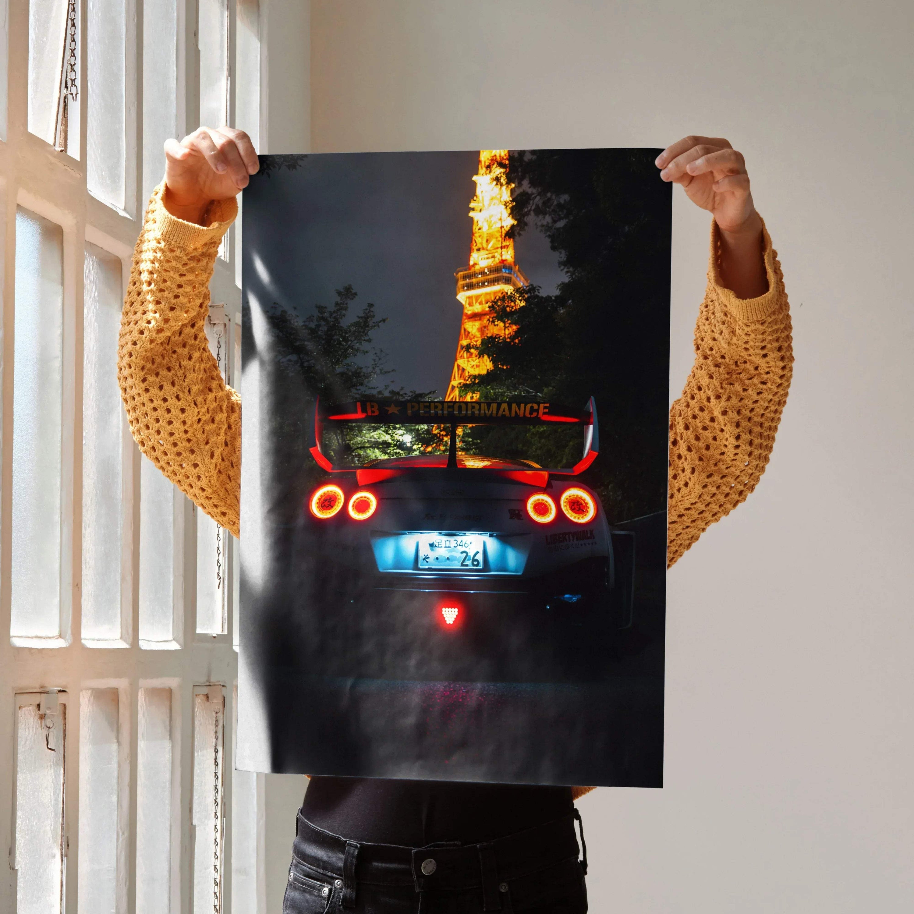Nissan GT-R R35 with illuminated taillights and Tokyo Tower in background poster wall art.