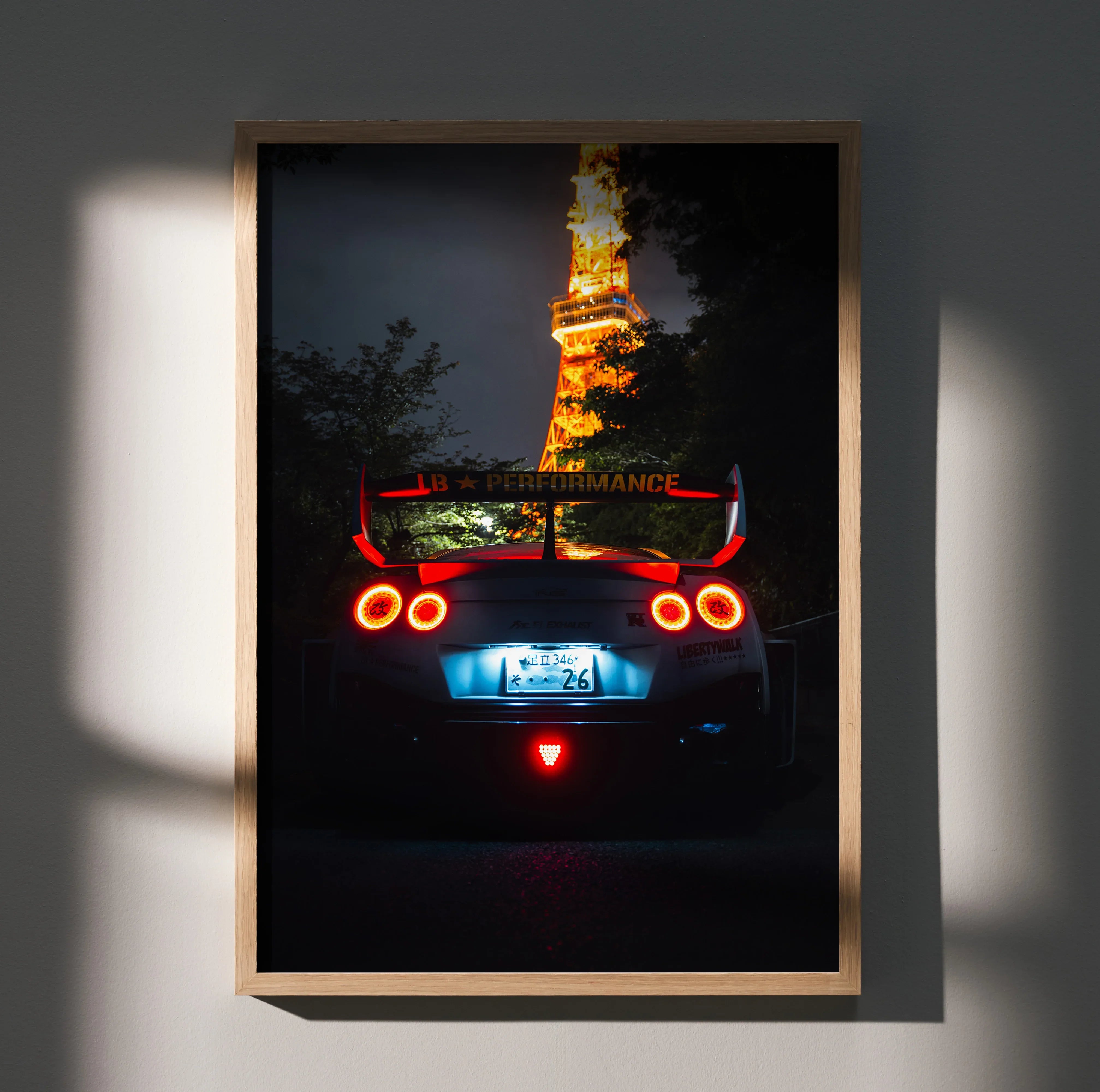 Nissan GT-R R35 poster showing rear view with illuminated taillights and Tokyo Tower backdrop wall art.