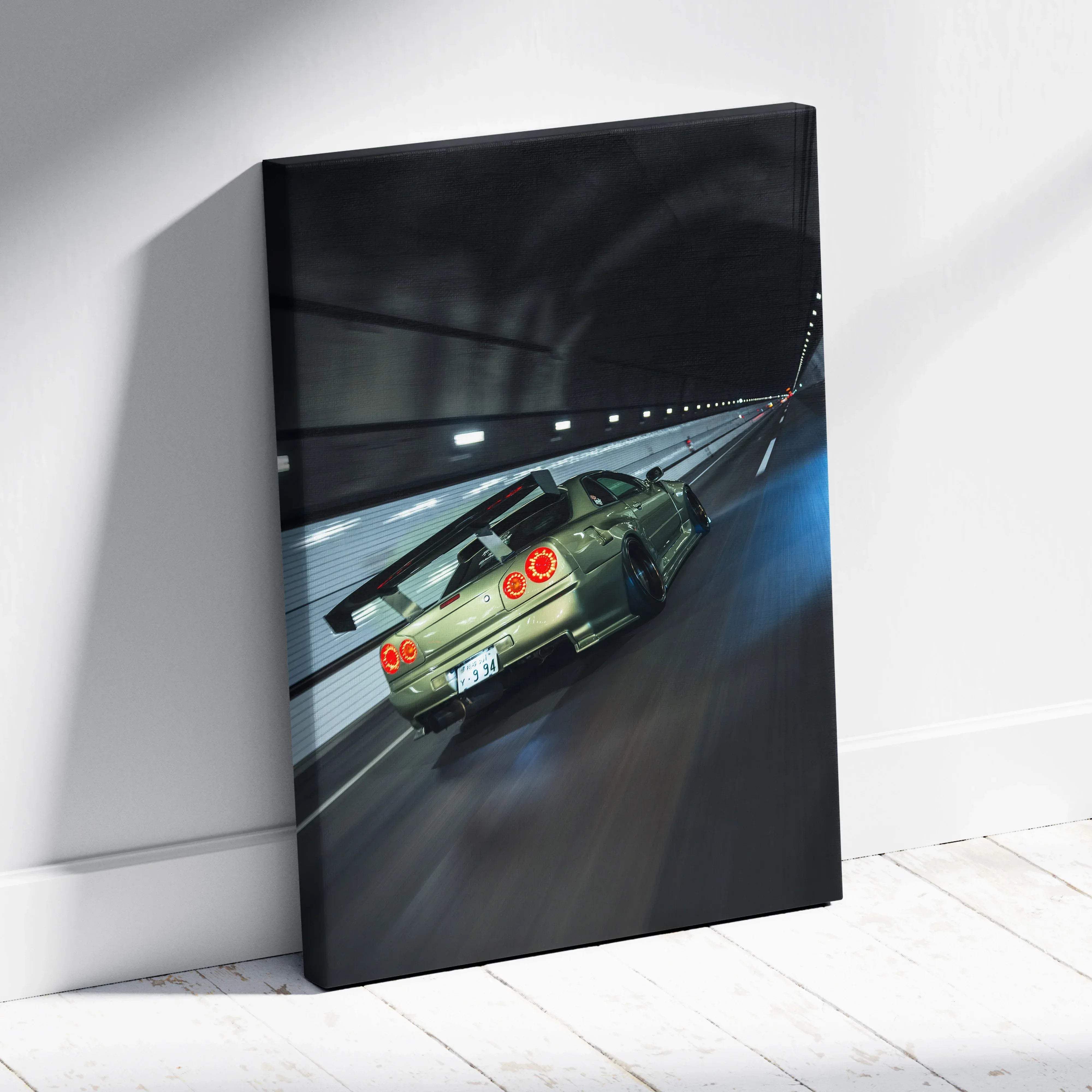 Canvas wall art featuring a sleek olive green nissan skyline r34 gtr in motion with glowing red taillights and blur effects