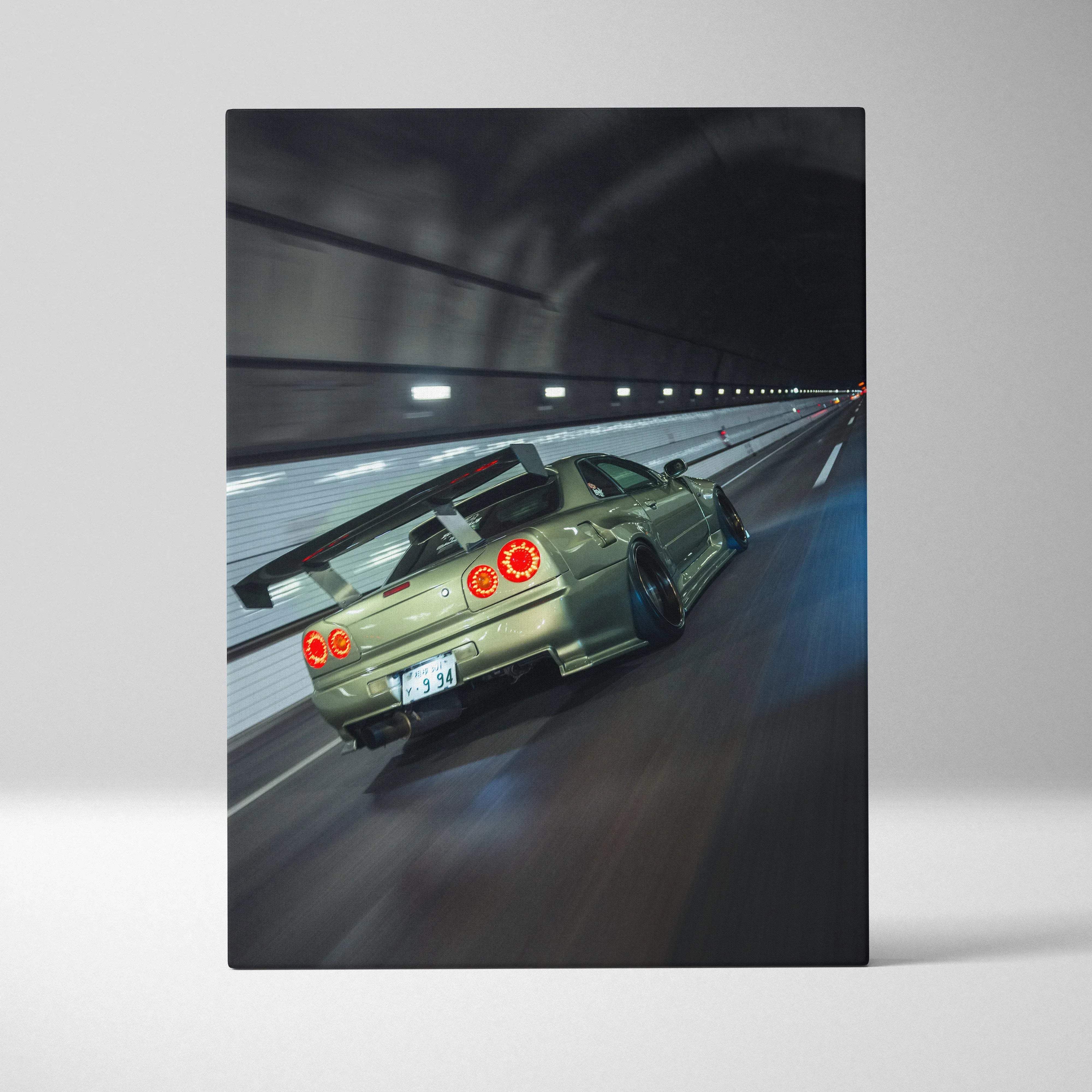 Canvas wall art showing the back of an olive green nissan skyline r34 gt-r with red taillights and a rear spoiler