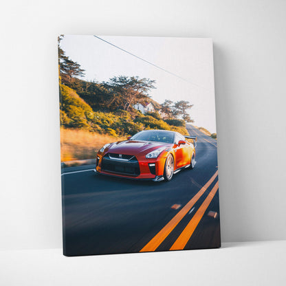 Red Nissan R35 GTR driving on road wall art canvas print with scenic background.