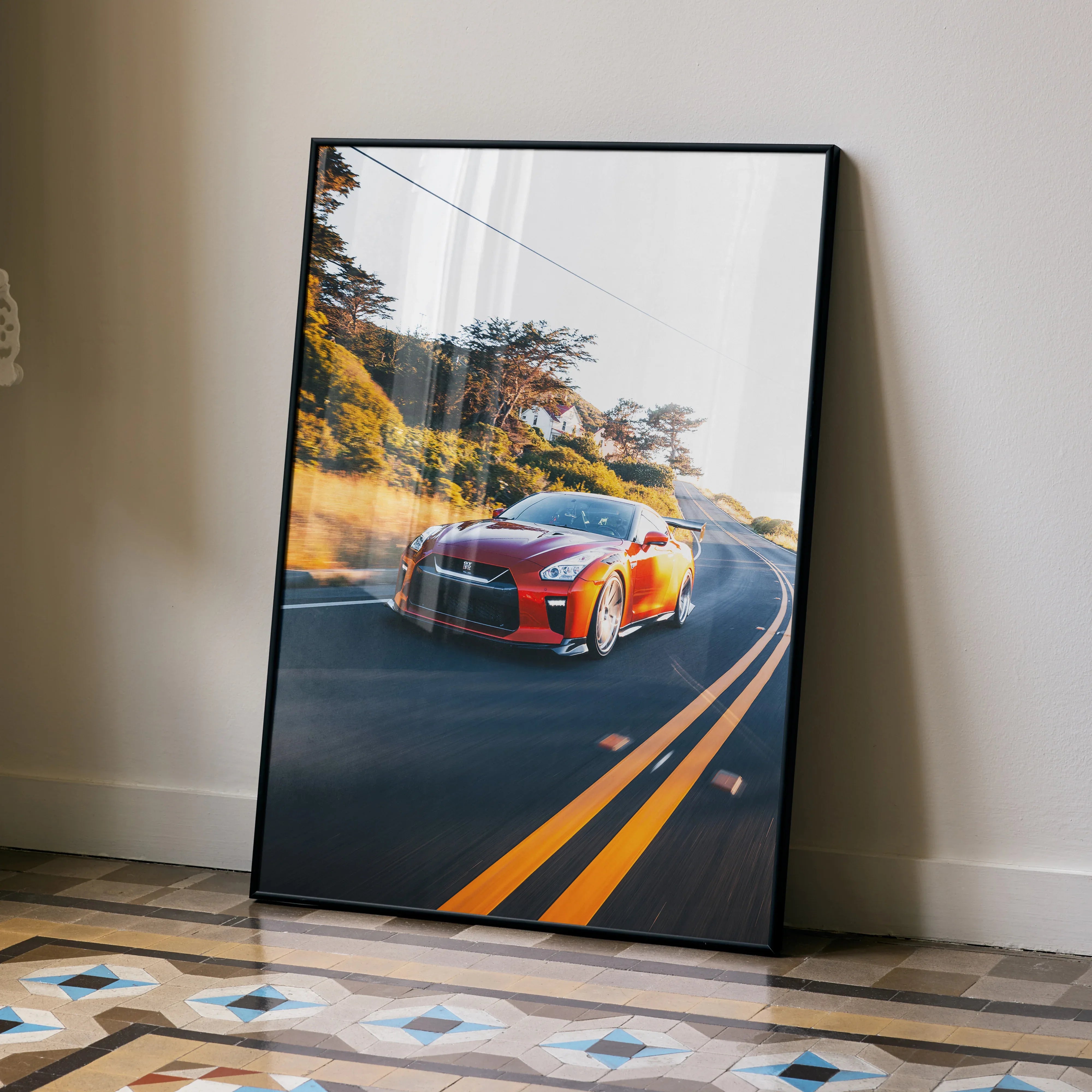 Nissan R35 GTR driving on winding road poster leaning on wall, vibrant car wall art.