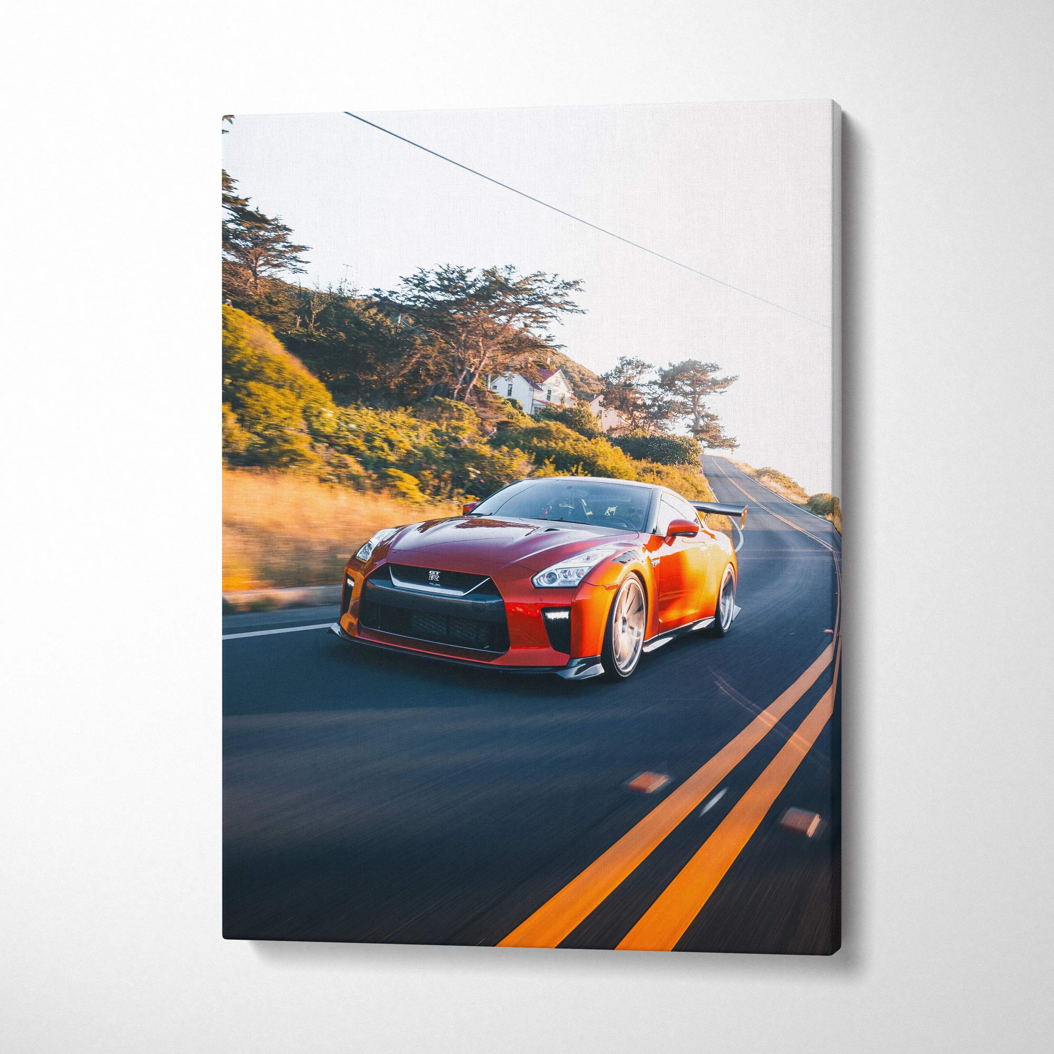 Nissan R35 GTR driving on winding road canvas wall art in bright orange color.