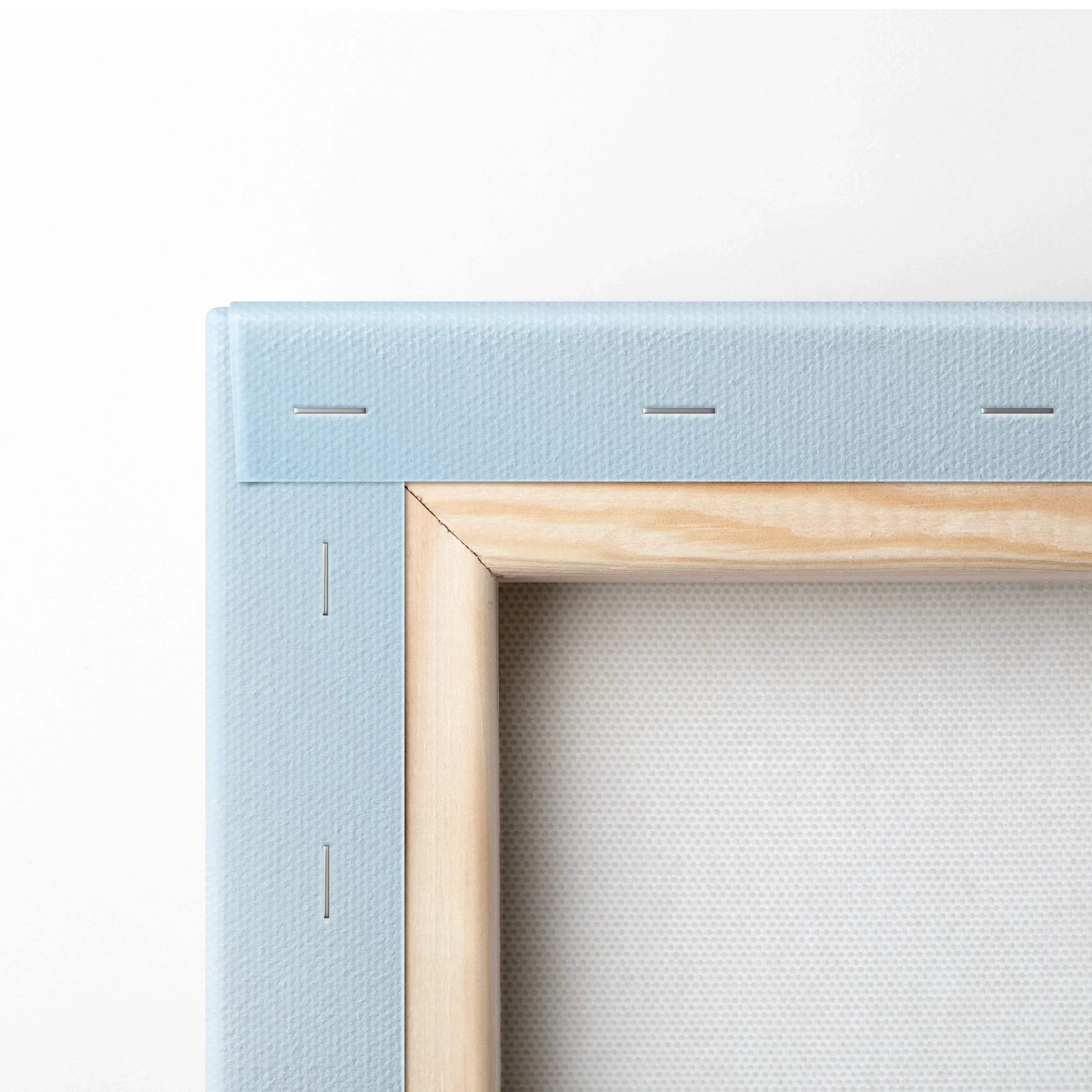 Close-up of wooden frame corner and blue canvas backing on vertical wall art canvas print.
