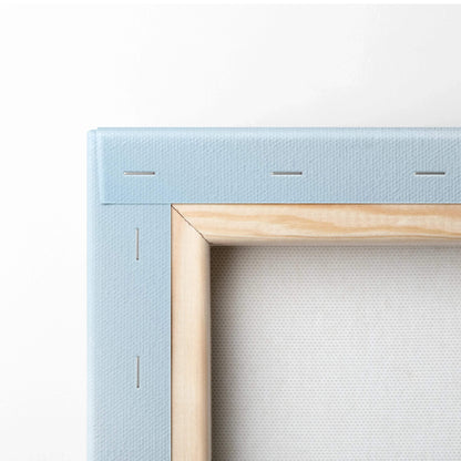 Close-up of wooden frame corner and blue canvas backing on vertical wall art canvas print.