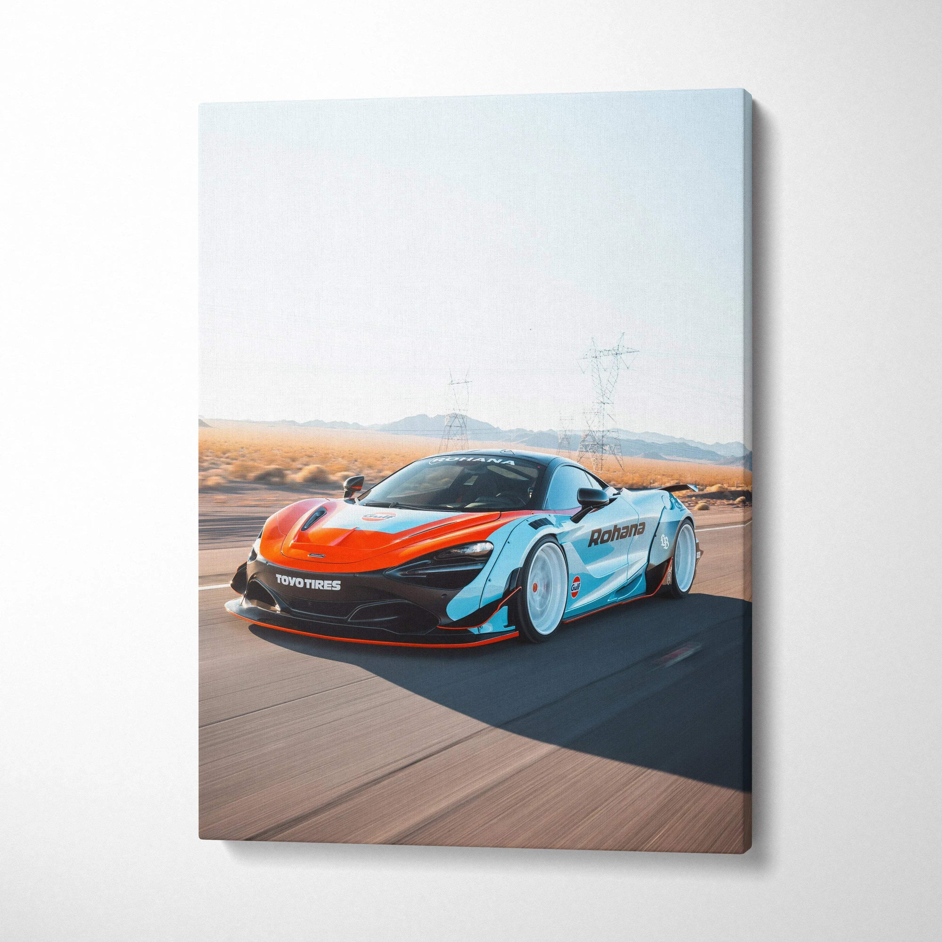 Vertical canvas wall art featuring a McLaren 720S in motion on a desert road.