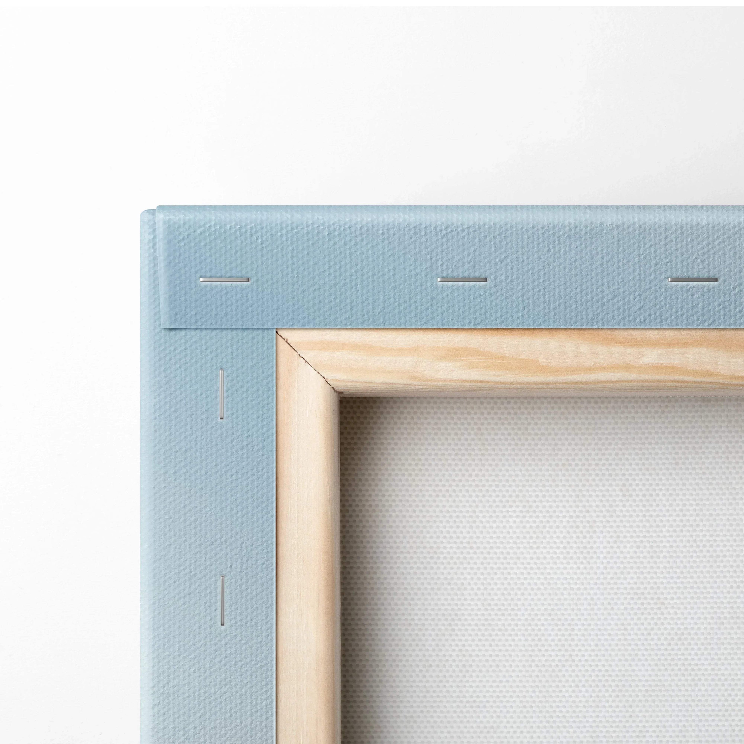 Close-up of blue stretched canvas with natural wood frame and visible staples for wall art canvas print.