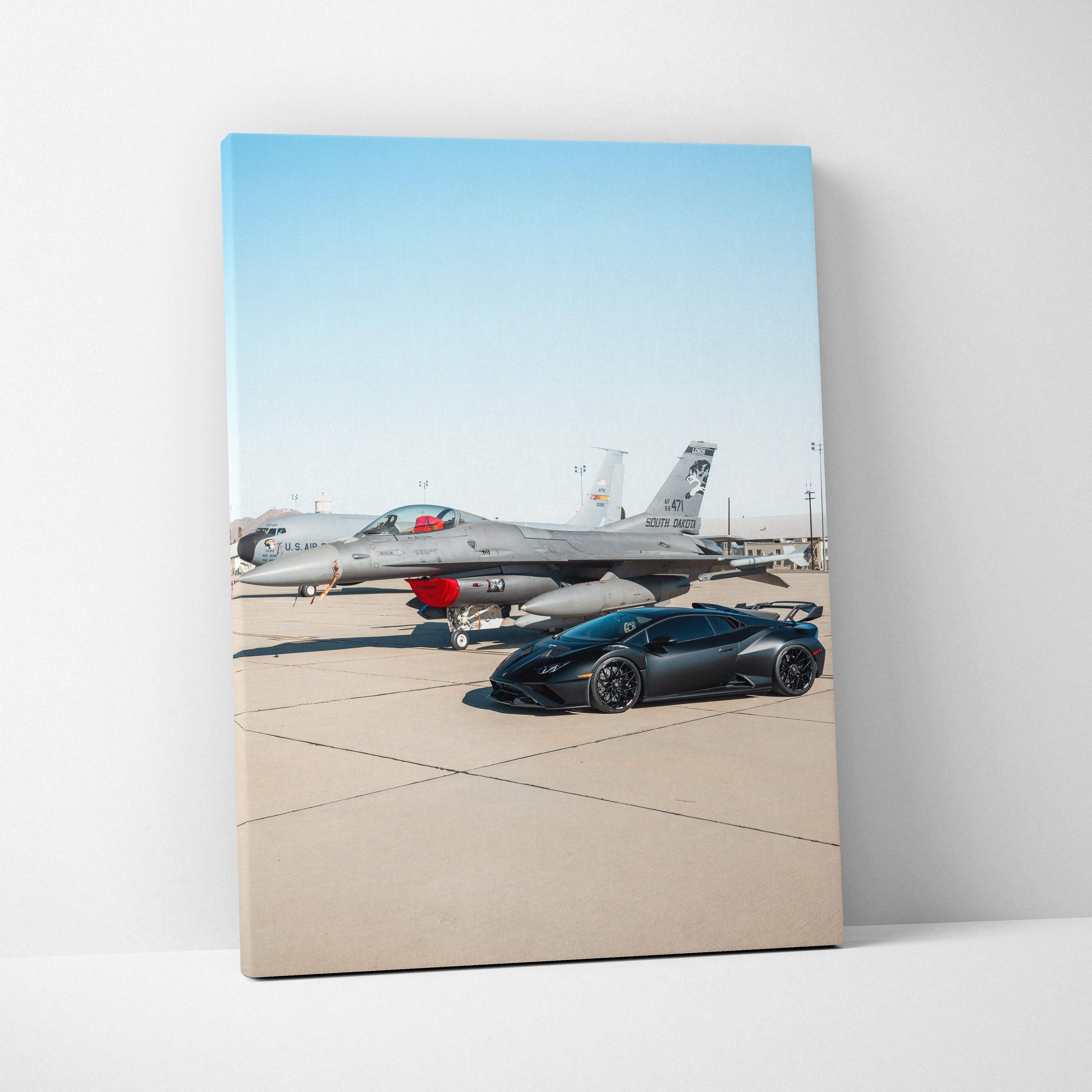 Vertical canvas wall art featuring a black Lamborghini Huracan STO parked on an airstrip with a military jet in the.