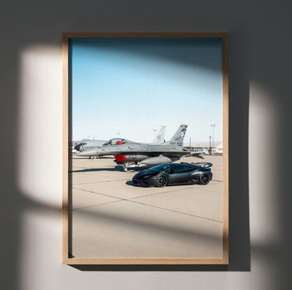 Lamborghini Huracan STO poster with sleek black car parked on runway near a jet, luxury wall art.