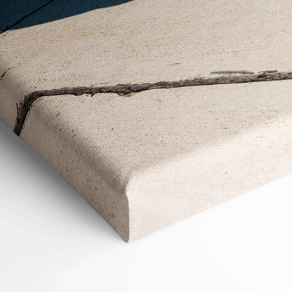 Close-up of textured canvas wall art corner with a subtle printed design on off-white fabric.