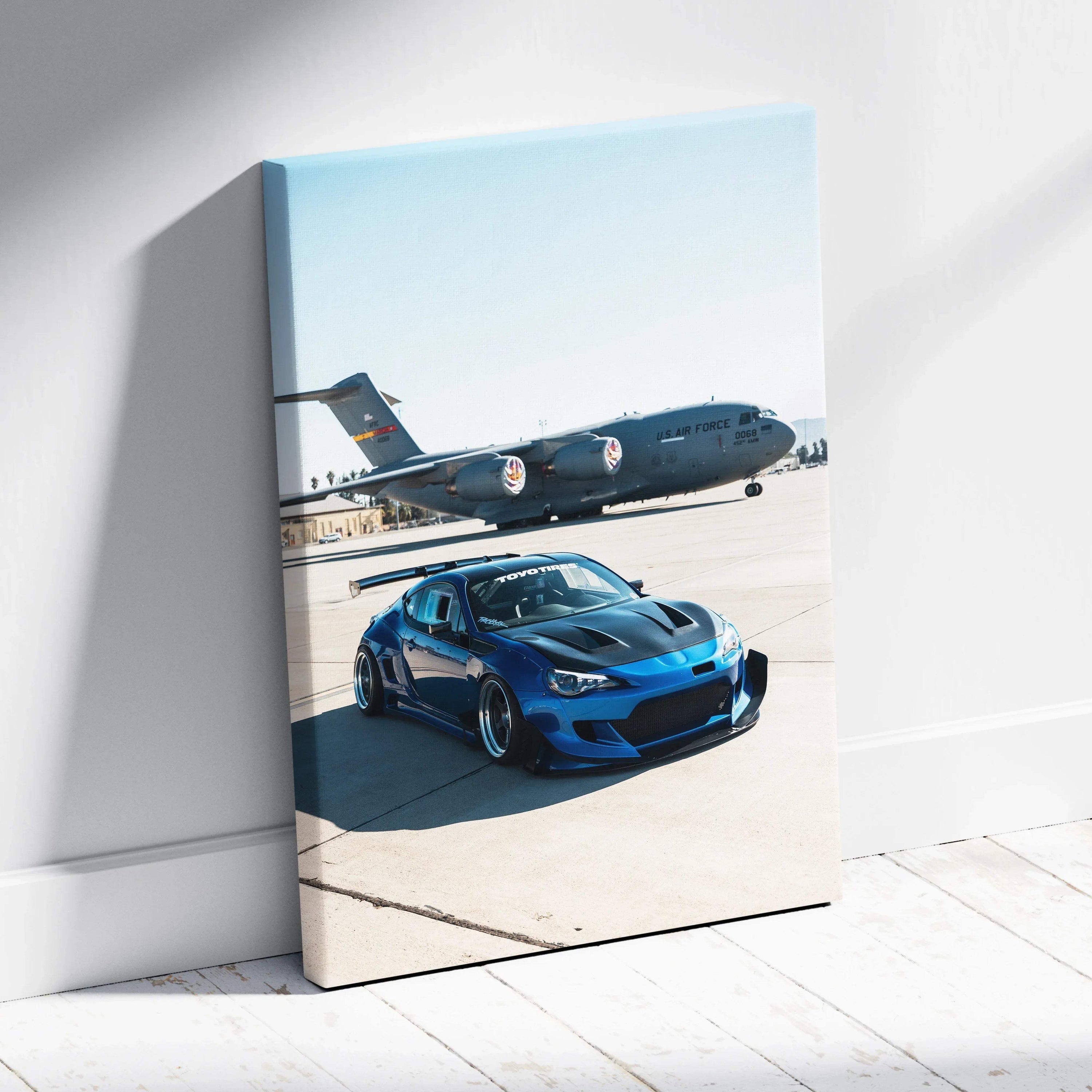 Blue Toyota FRS parked on runway with airplane background vertical canvas wall art.