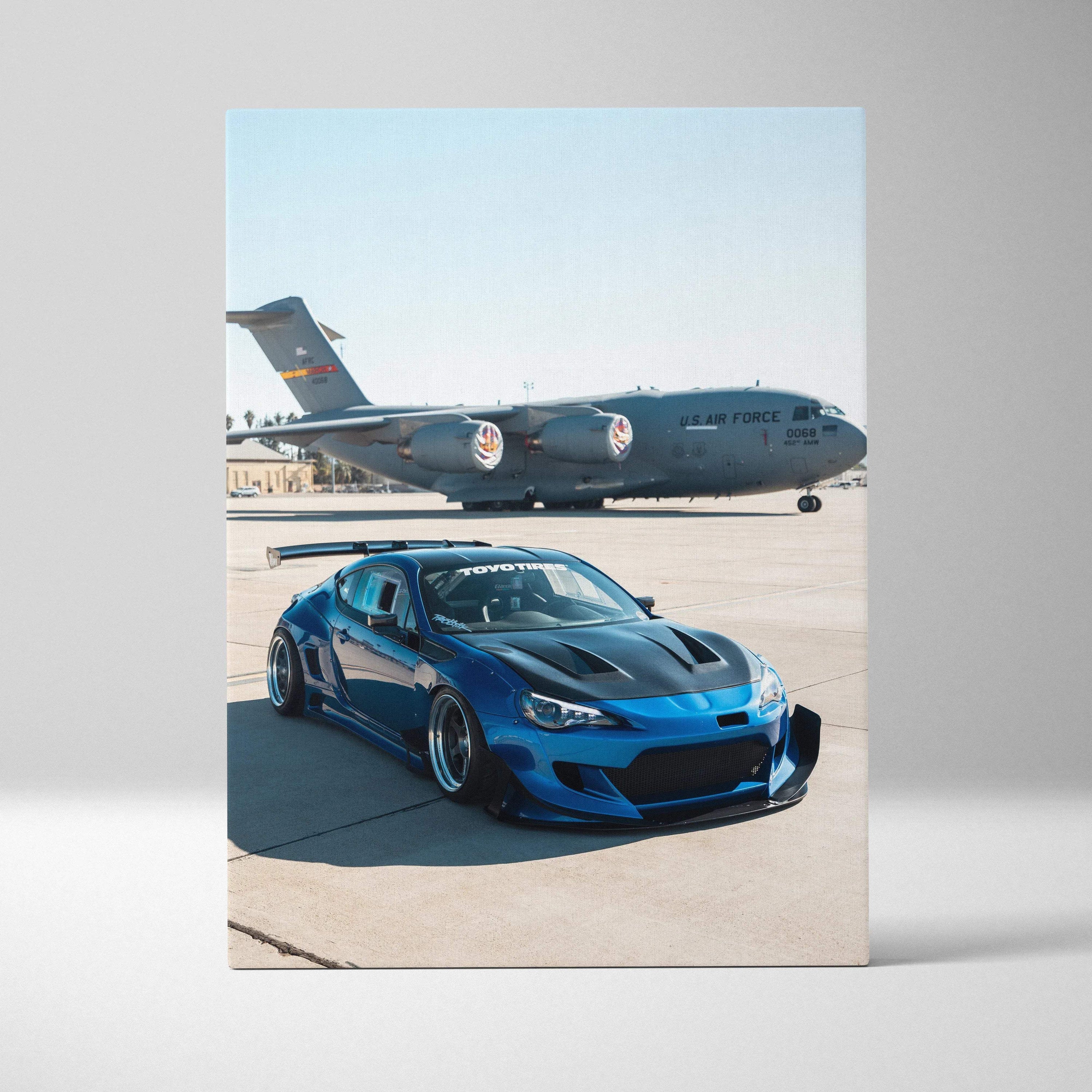 Toyota FRS blue sports car on runway with cargo plane backdrop canvas wall art.