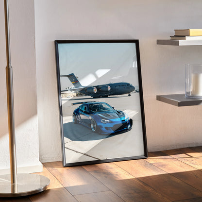 Toyota FRS poster wall art featuring a sleek blue sports car parked by a jet on runway.