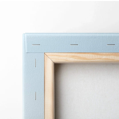 Close-up of stretched canvas art with wooden frame stretcher bars and blue fabric backing for wall art display.