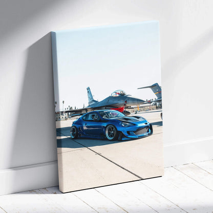 Blue Toyota FRS parked on runway with fighter jets in background vertical canvas wall art.