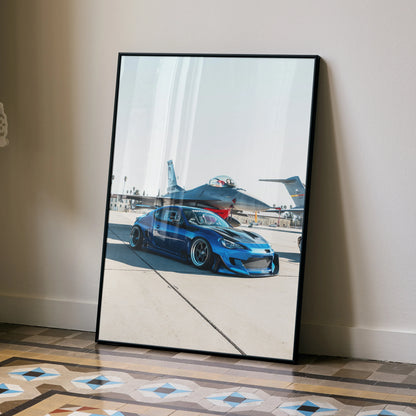 Sleek modified blue Toyota FRS poster leaning on wall showing sporty car and airplane runway wall art.