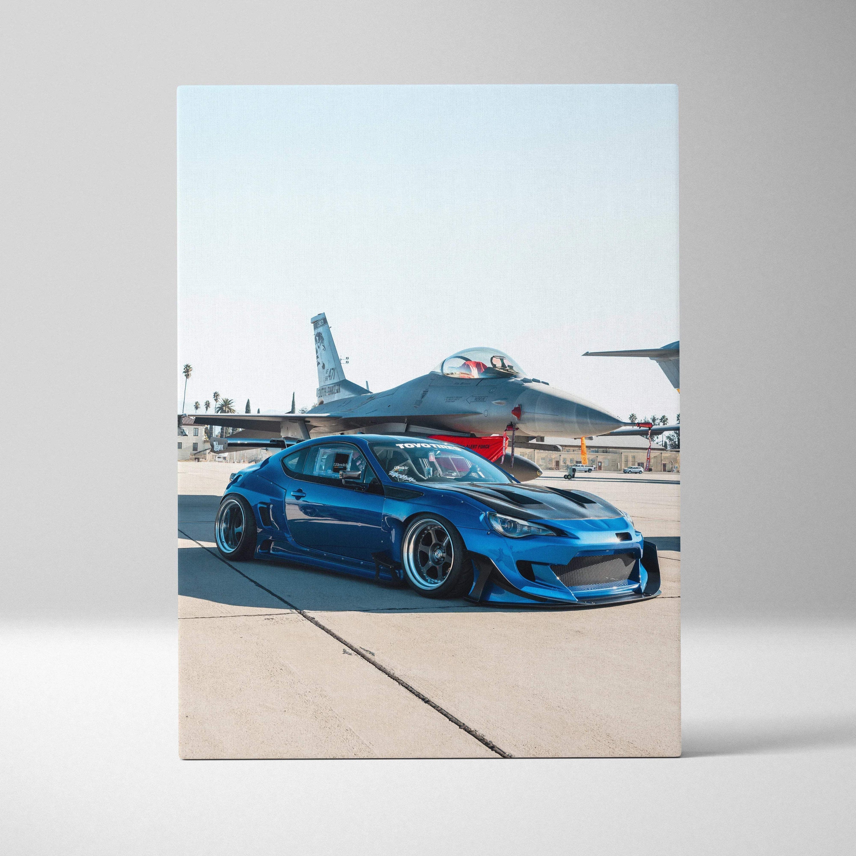 Blue Toyota FRS sports car with fighter jet in background vertical canvas wall art.