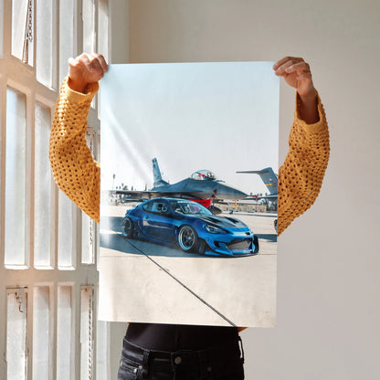 Blue modified Toyota FRS parked on runway with jet in background poster wall art.
