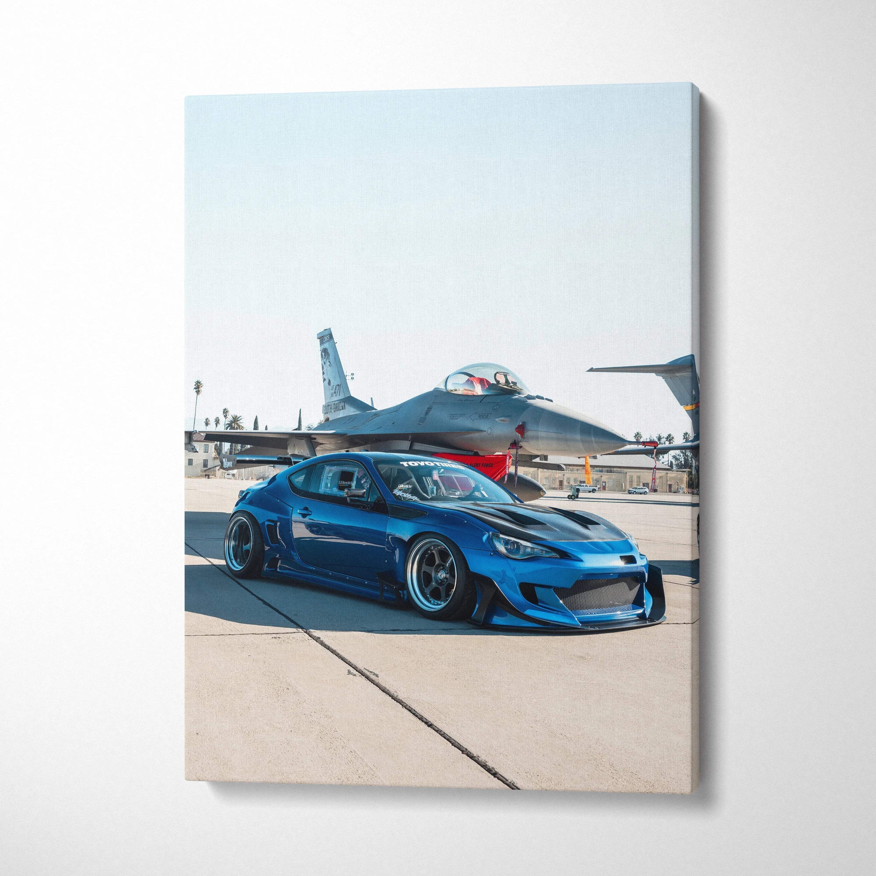 Blue Toyota FRS car with fighter jet background on vertical museum-quality canvas wall art.
