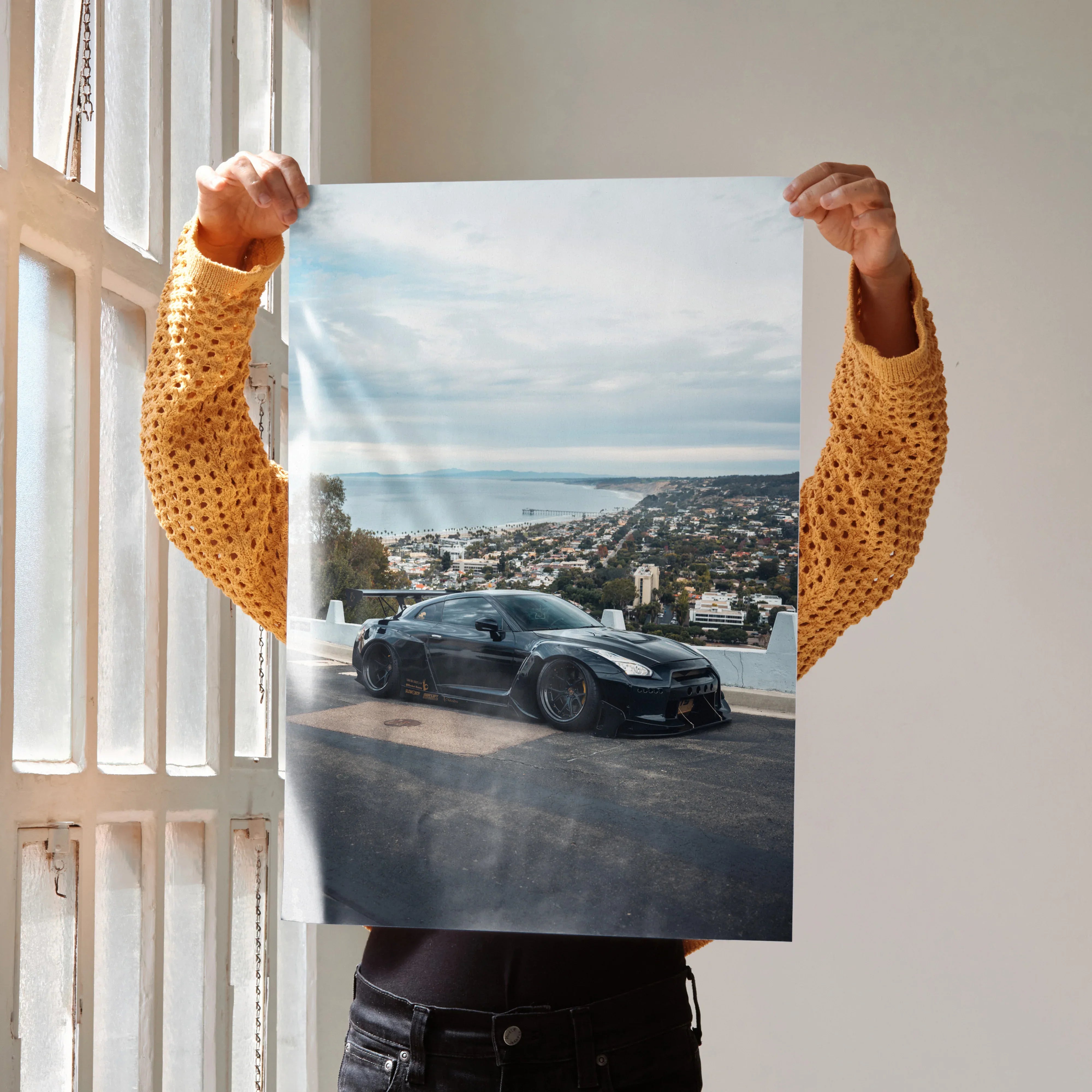 Nissan GTR R35 parked on scenic coastal road poster wall art with clear sky background.