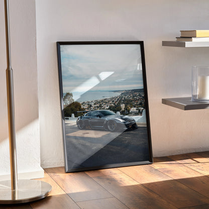 Nissan GTR R35 car parked by a scenic coastal overlook framed as wall art poster.