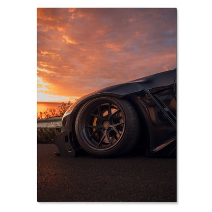 Sleek Nissan GTR R35 poster featuring close-up of black wheel and low front fender at sunset wall art.