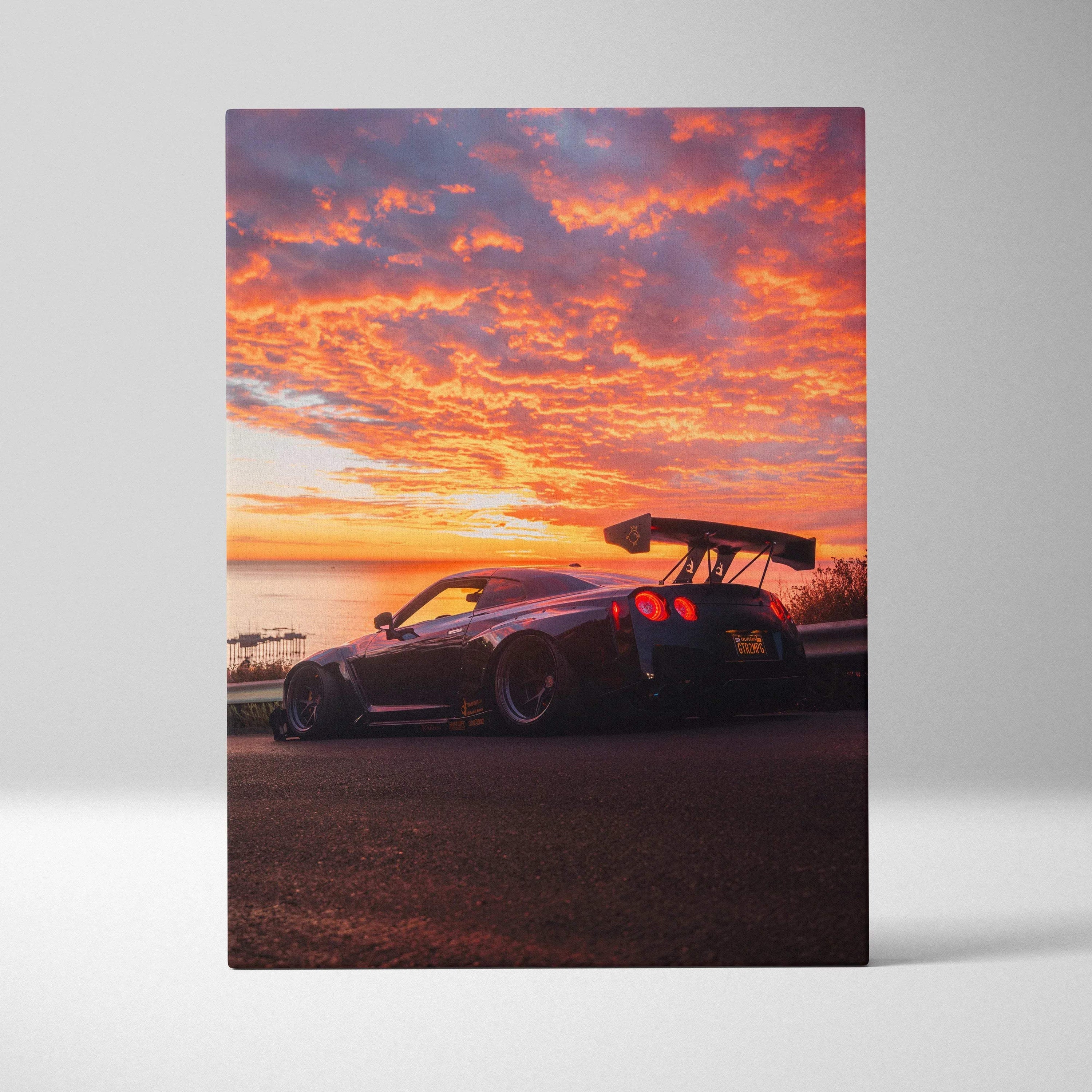 Nissan R35 GTR canvas art showing car silhouette against vibrant orange sunset sky, vertical wall art.
