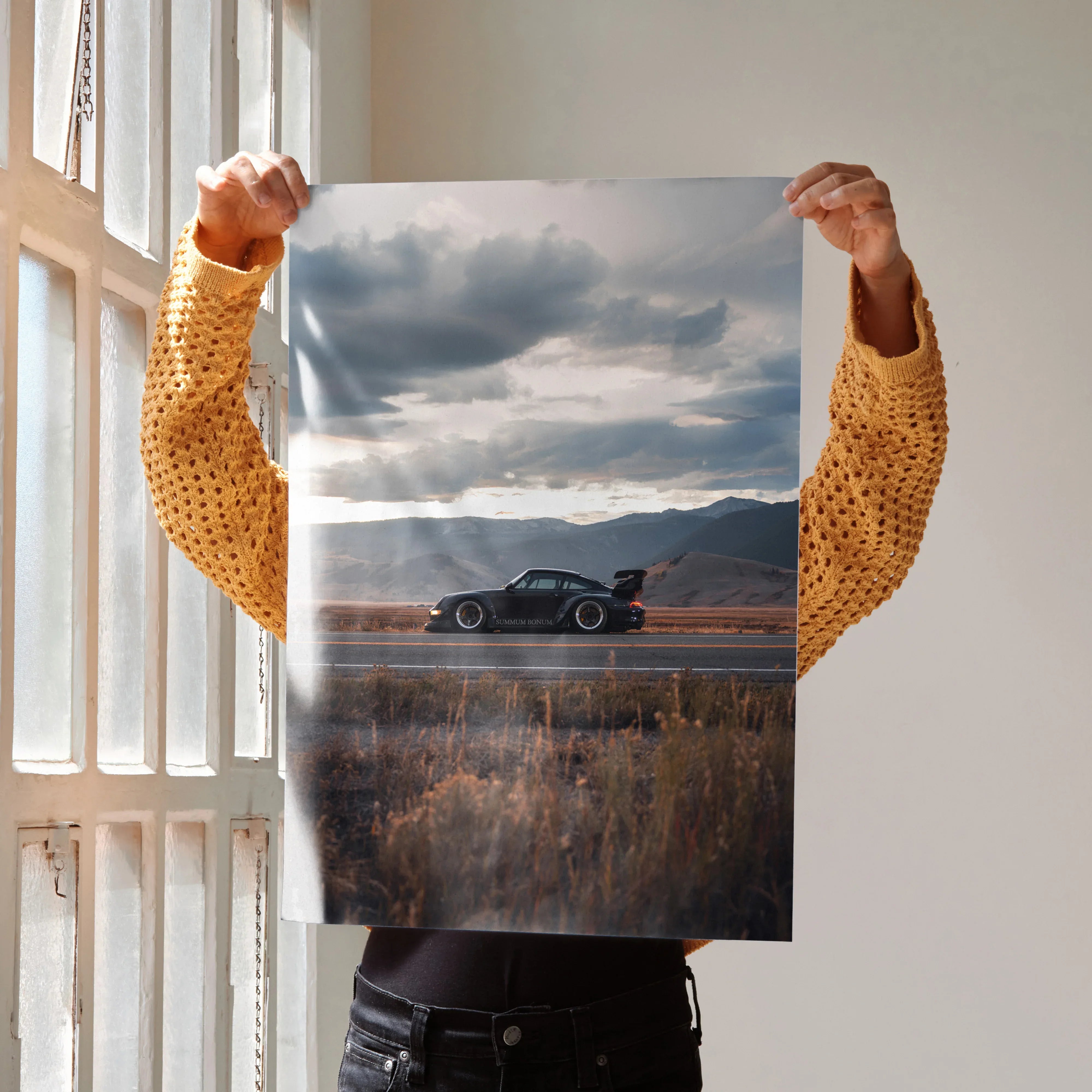 RWB Porsche 911 poster featuring a black sports car on a scenic road at sunset, wall art with dramatic clouds.