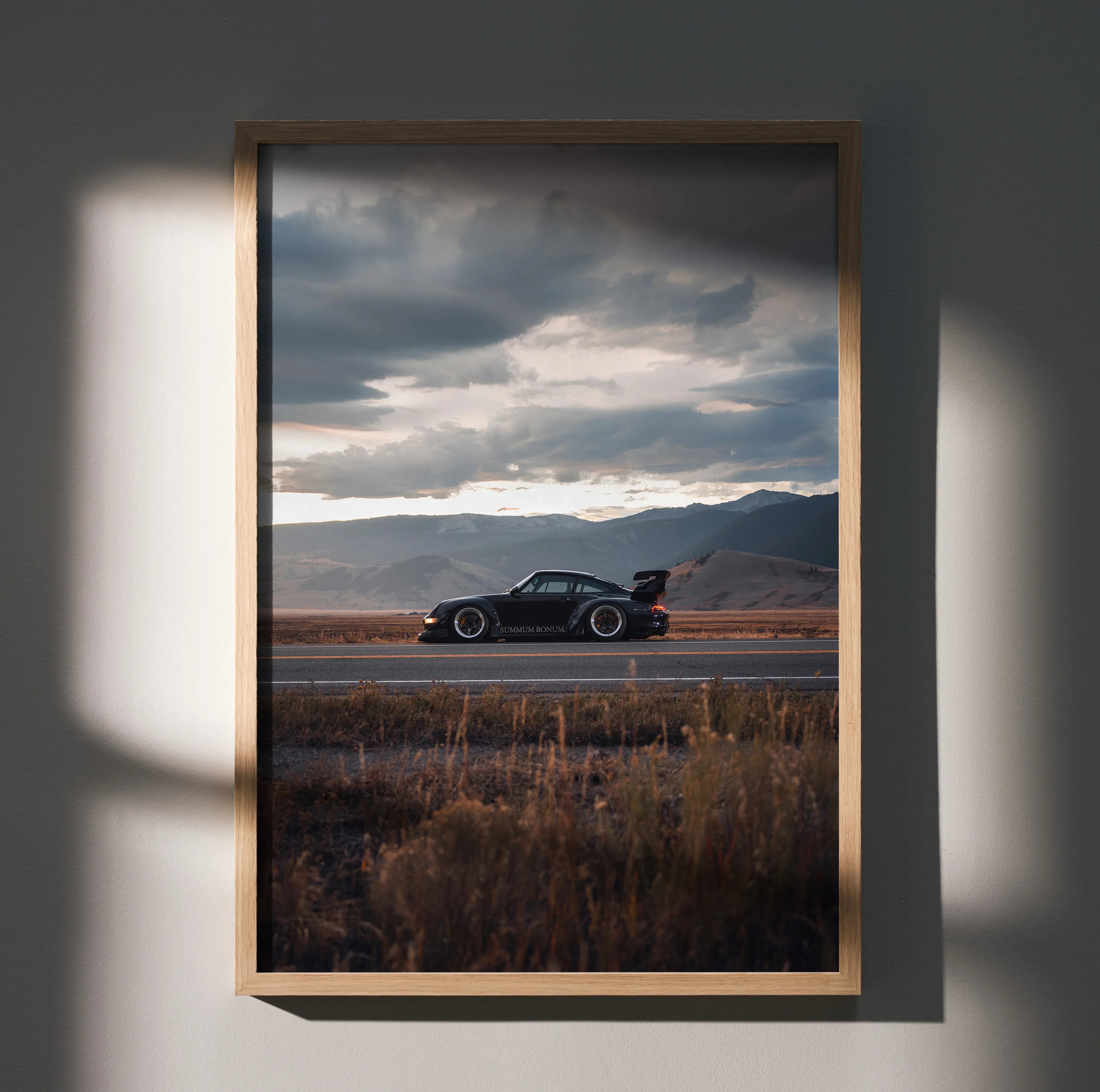 RWB Porsche 911 poster wall art with dark car silhouette on open road and dramatic cloudy sky.