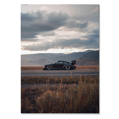 RWB Porsche 911 side view on scenic road with dramatic cloudy sky poster wall art.
