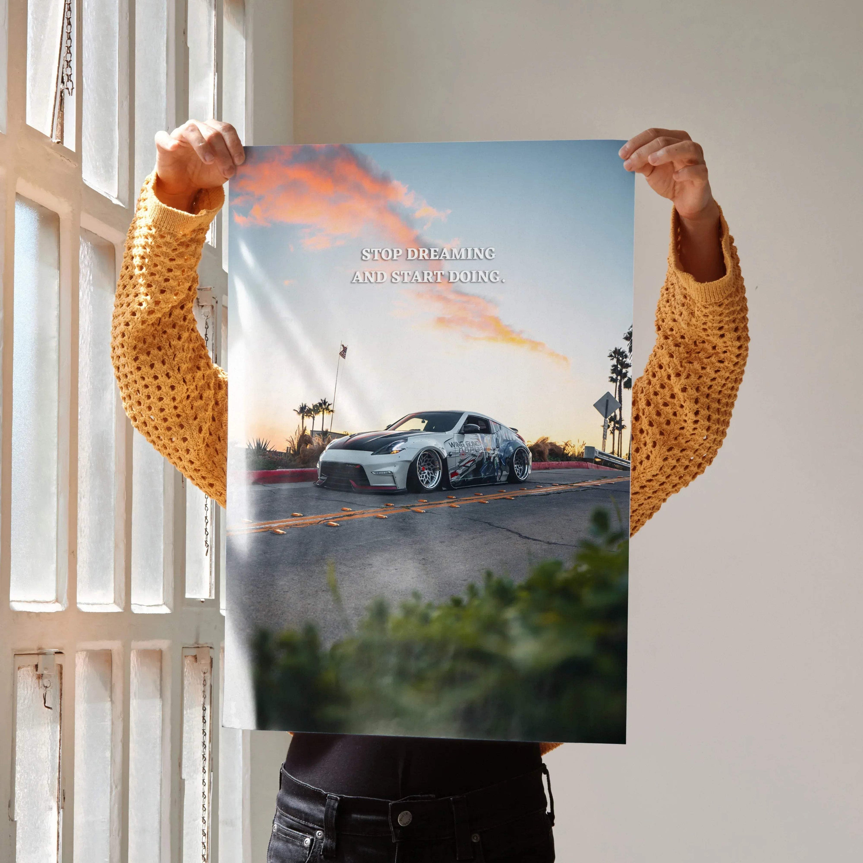 Motivational poster wall art featuring a Nissan 370z on a scenic road at sunset with inspiring text.