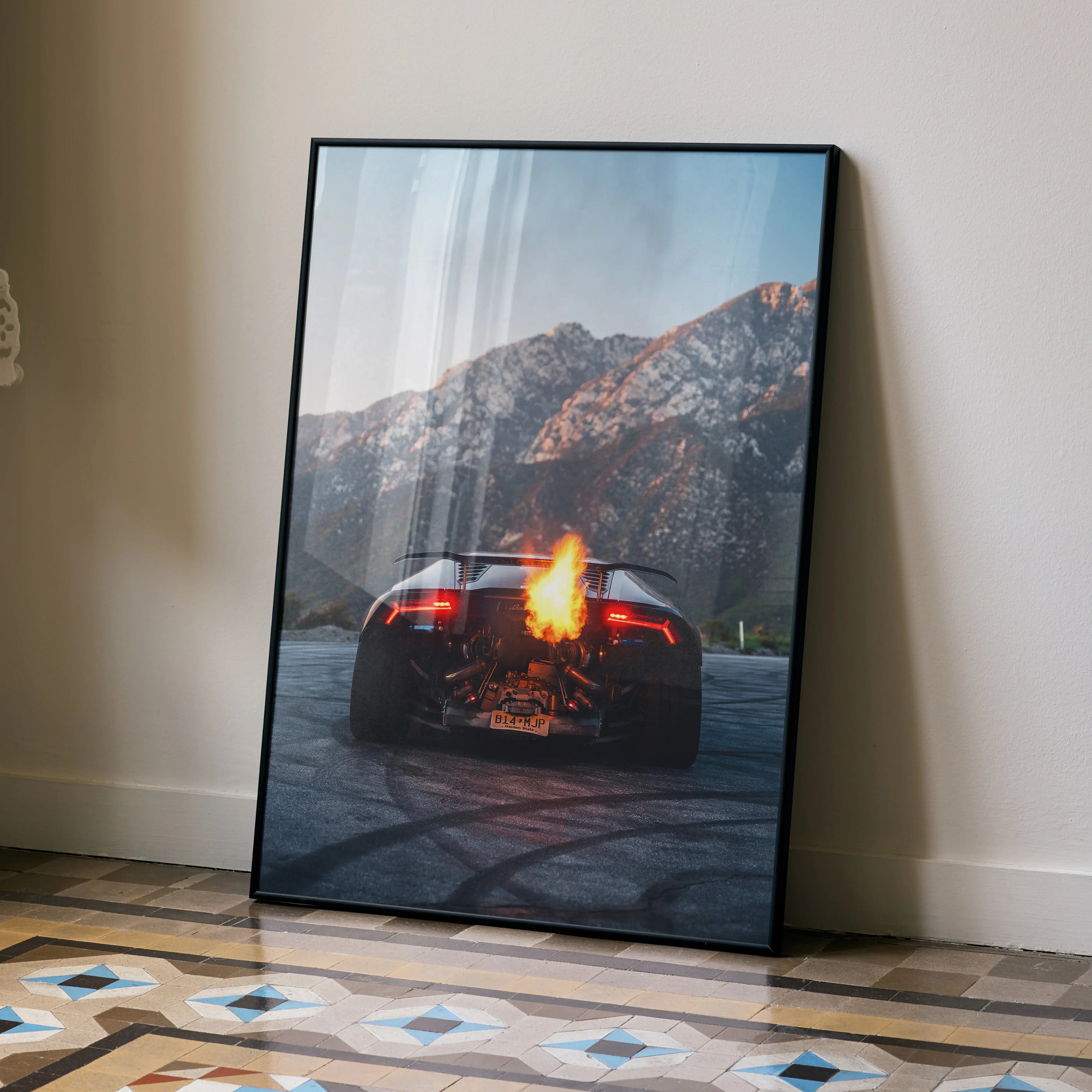 Lamborghini Huracan Poster with fiery flame effect at rear, mountain backdrop, sleek black frame wall art.