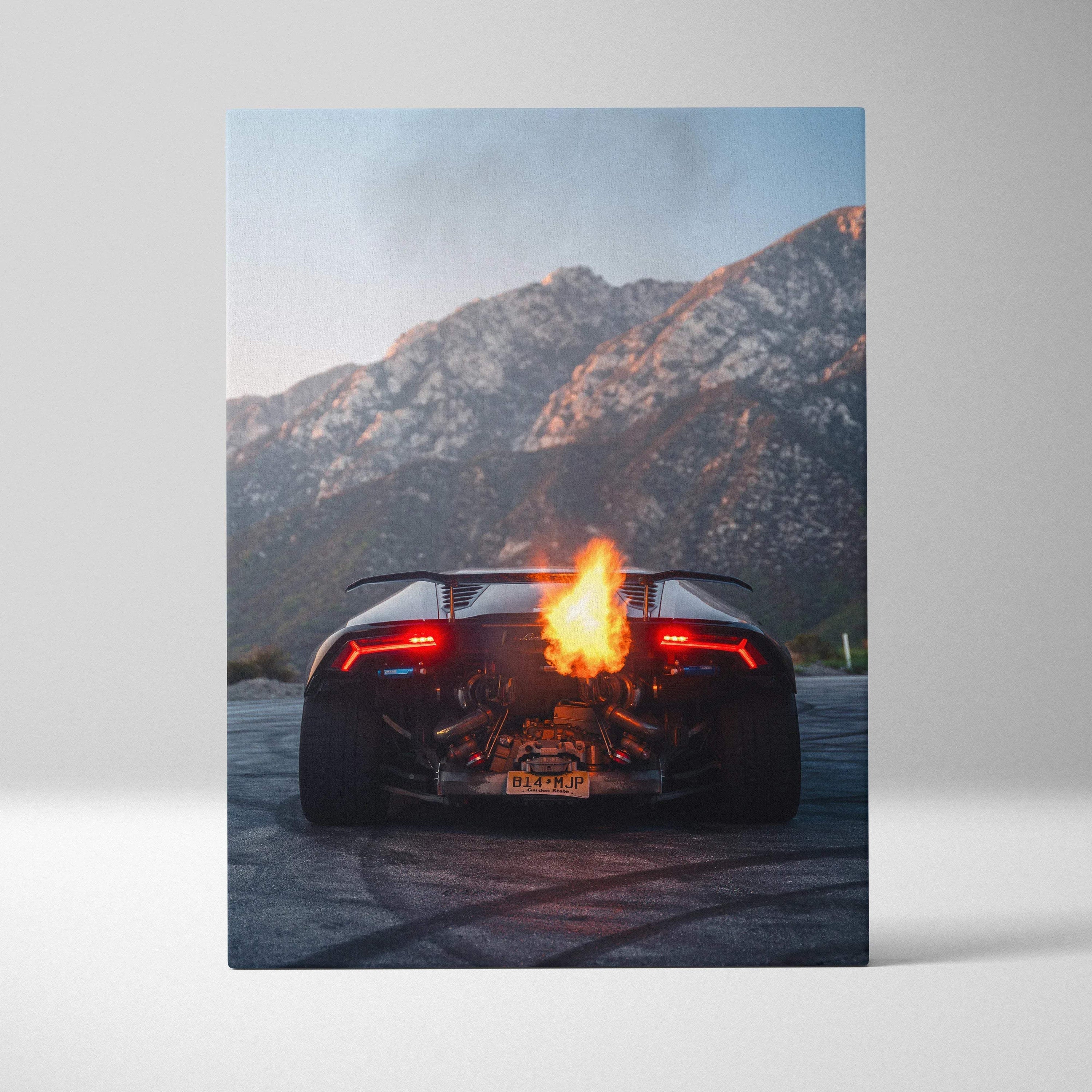 Lamborghini Huracan rear view with flame exhaust on canvas wall art against mountain backdrop.