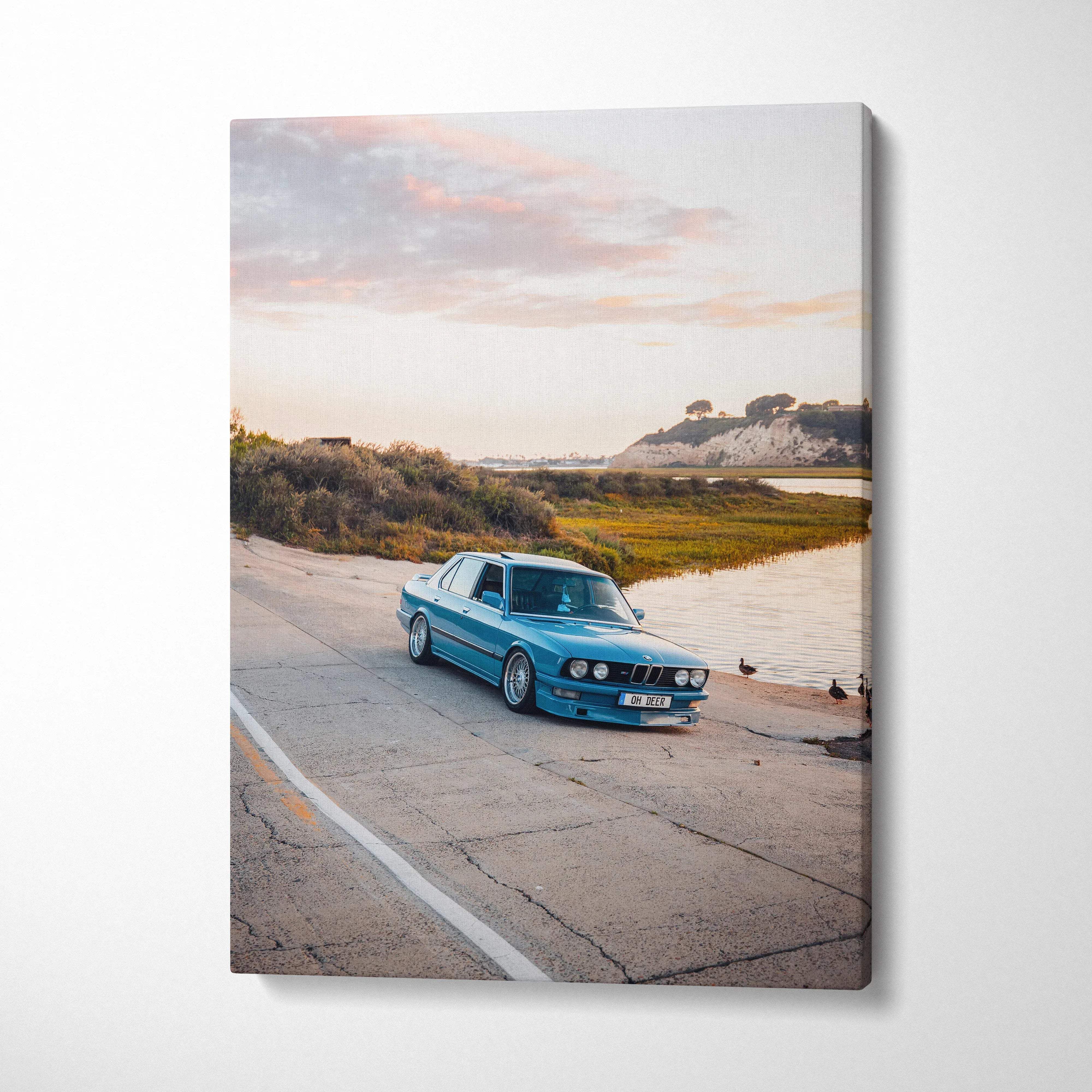 BMW E28 5 Series vintage car on coastal road canvas wall art in soft natural light.
