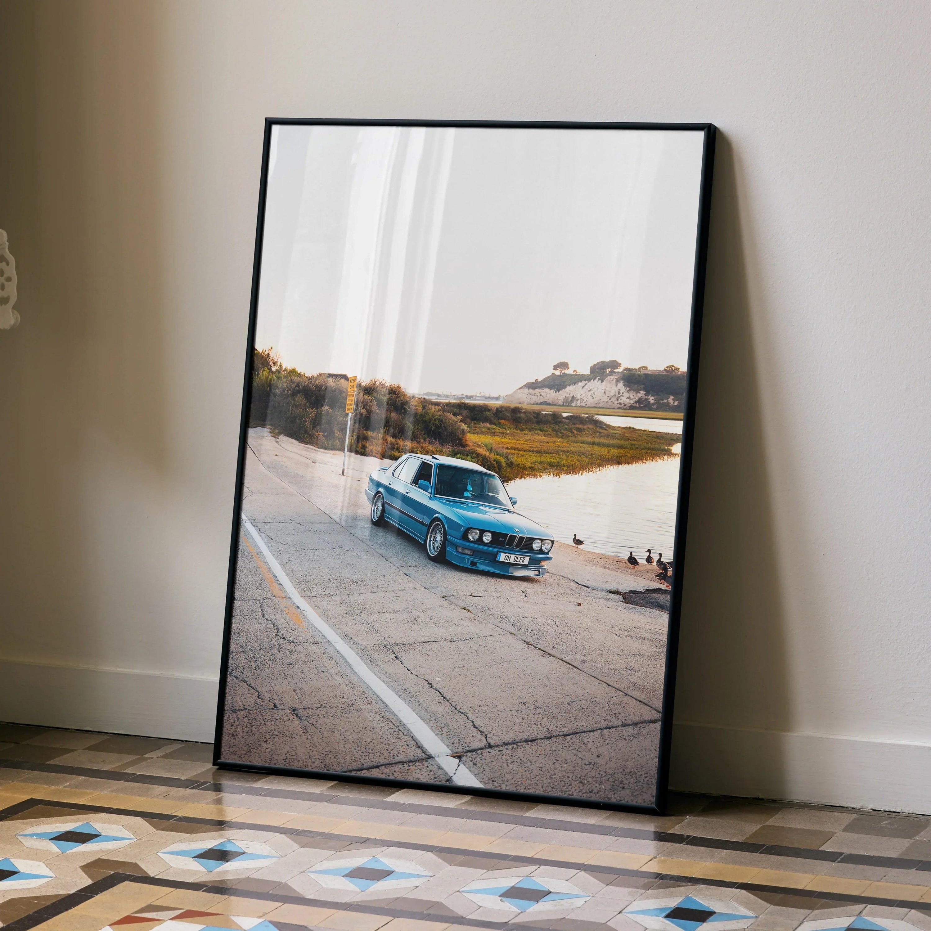 BMW E28 5 Series classic car poster with scenic sunset background, framed wall art.