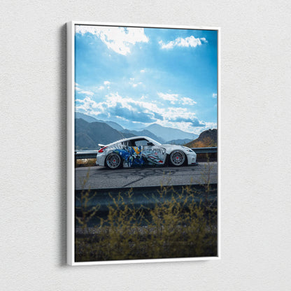 Vertical canvas wall art featuring a white Nissan 370z with colorful decals against a mountainous sky background.