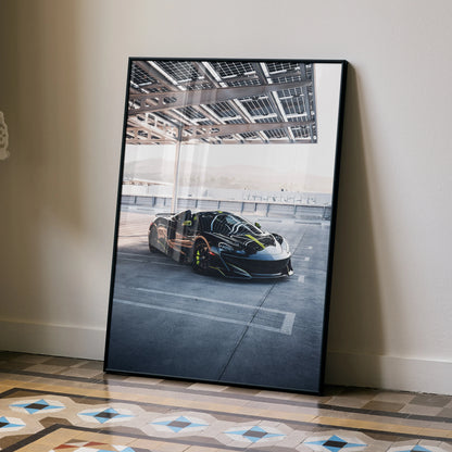 McLaren 600LT supercar poster leaning against wall, high-resolution wall art with sleek black sports car design.