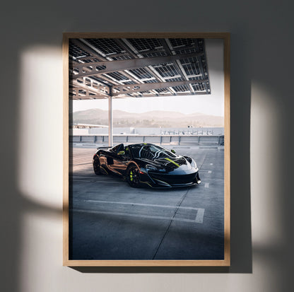 McLaren 600LT supercar in dark color with neon green accents parked under a modern canopy poster wall art.