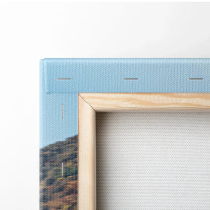 Close-up of wooden frame corner and stretched canvas fabric on vertical wall art print.