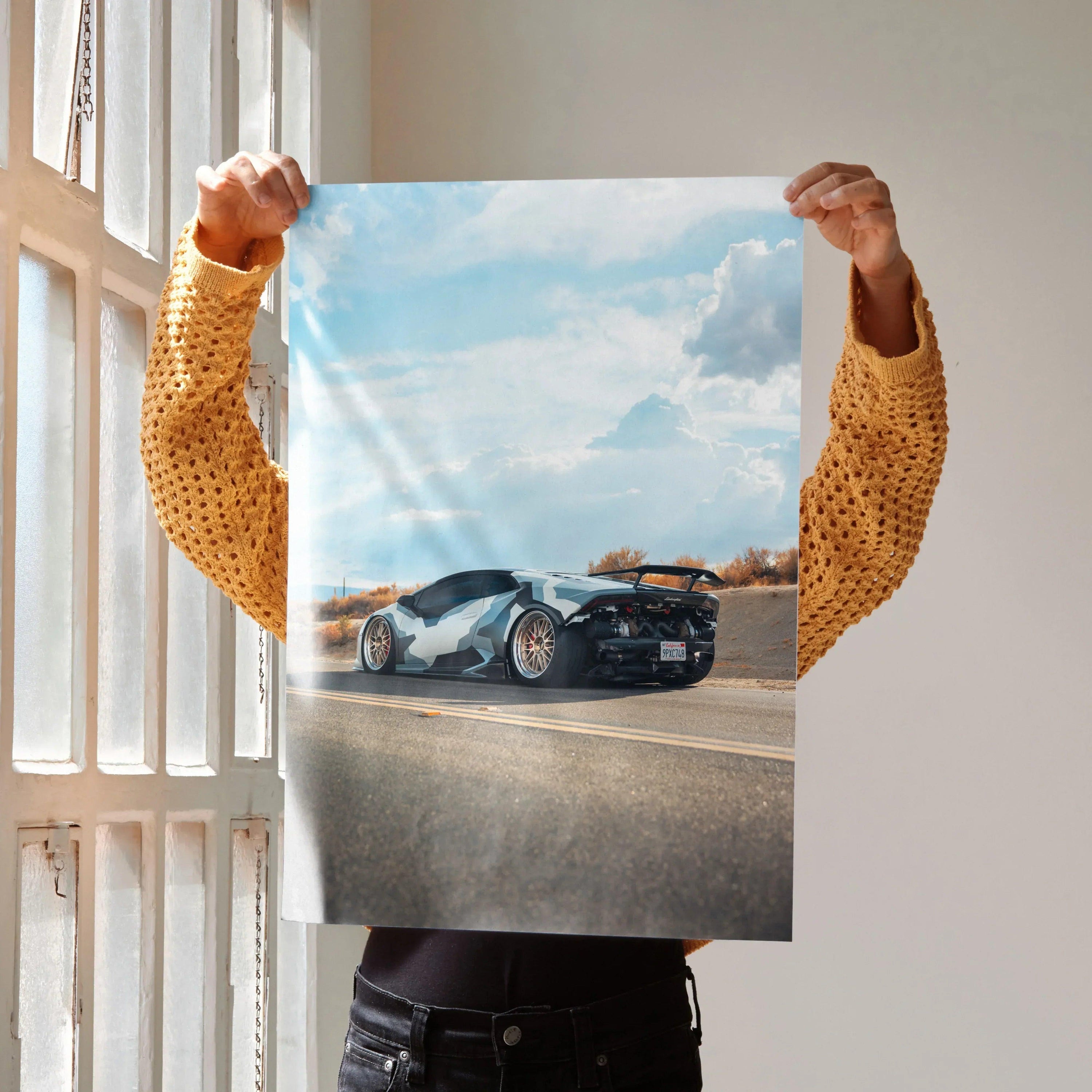 Lamborghini Huracan poster showing black sports car on road under blue sky, wall art print.