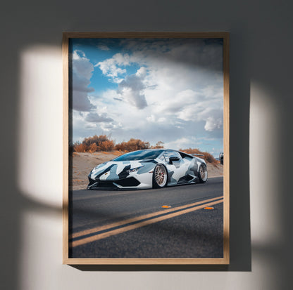 Lamborghini Huracan poster featuring a sleek silver sports car on a road under a dramatic cloudy sky, wall art in a wooden.
